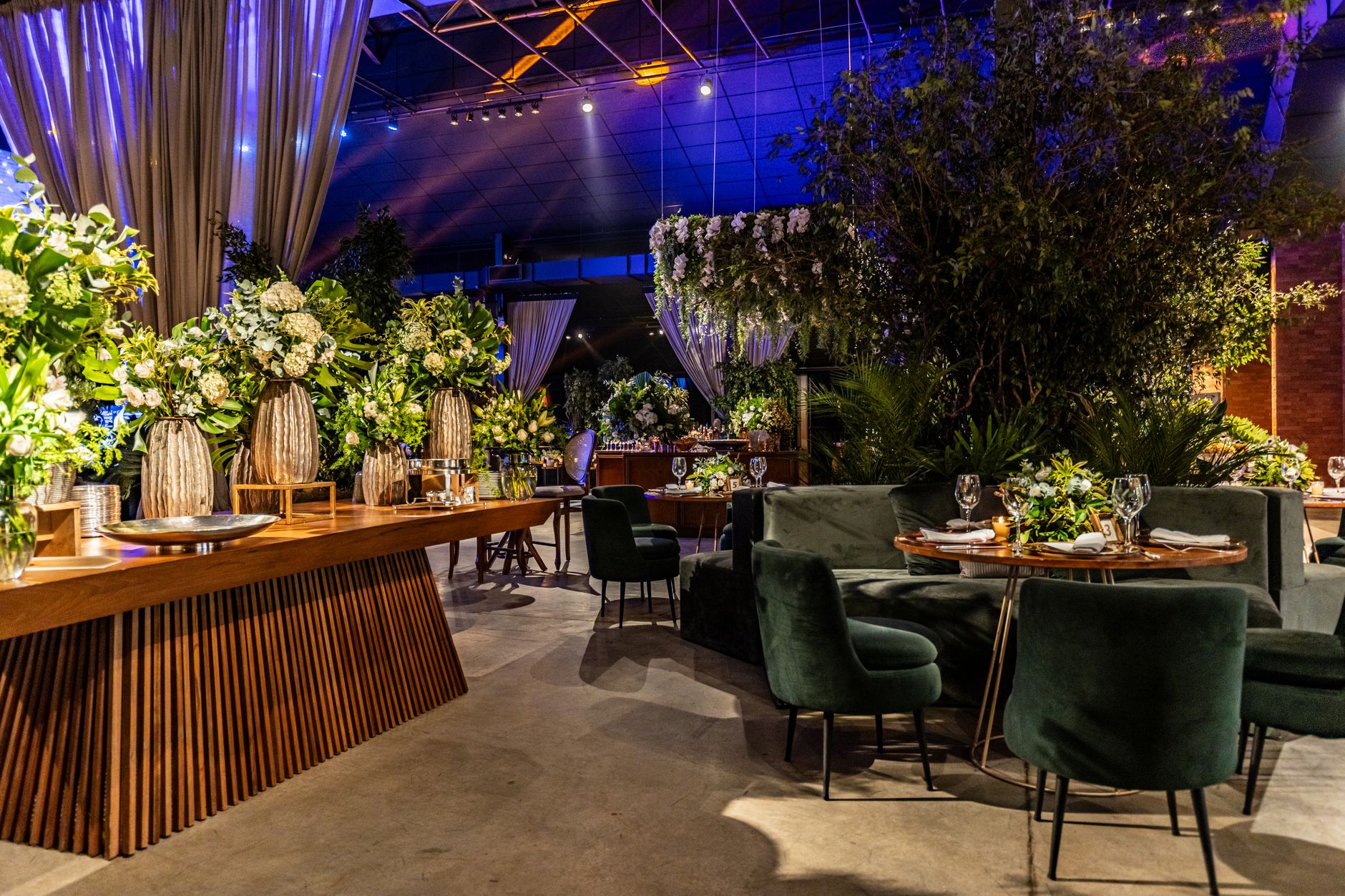 Chic indoor banquet setup featuring lush green floral arrangements and modern table settings. — "Comprehensive Wall Paneling