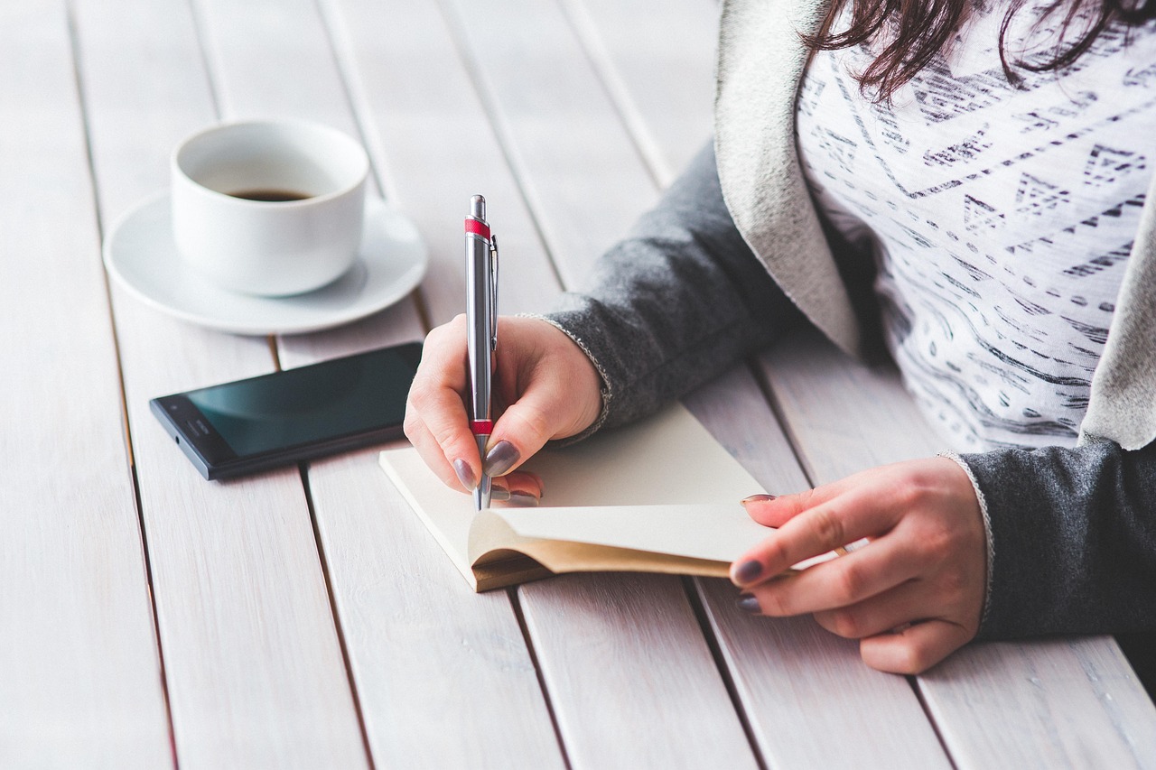 Woman, write, notepad — Computer Forensics Services Helping Organizations Manage Incident Response Effectively and Efficientl