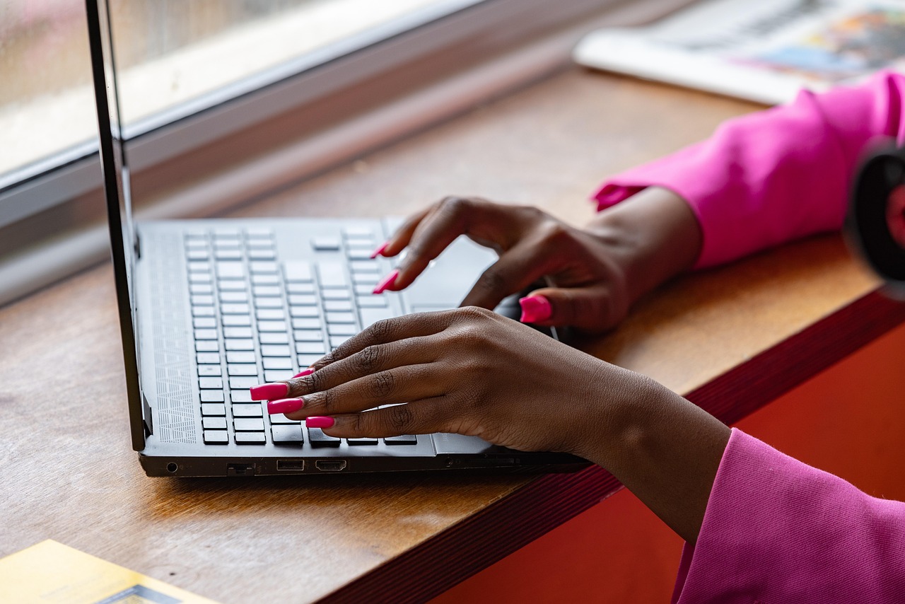 Laptop, typing, working — Essential Online Tools: Top USA Services for SMS Reception